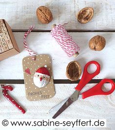 a wooden table topped with christmas decorations and nuts