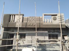 scaffolding on the side of a building that is being constructed with concrete and wood