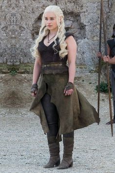 game of thrones daeneria starke cosplaying in front of a stone wall