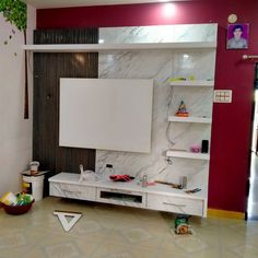 a living room with a large white tv on the wall