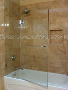 a bath tub sitting next to a tiled wall in a bathroom with beige tiles on the walls