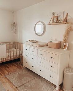 a baby's room with a crib and dresser