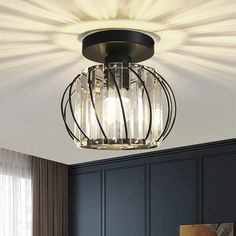 a ceiling light that is hanging from the ceiling in a room with dark blue walls