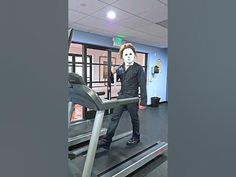 a man in a mask is walking on a treadmill