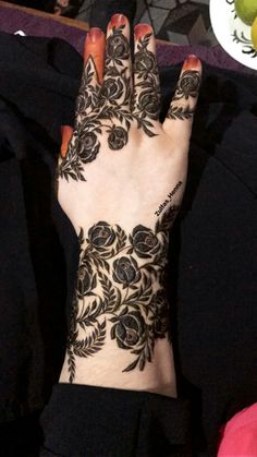 a woman's hand with henna on it