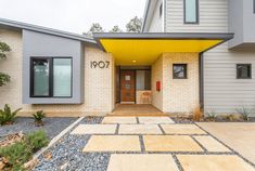 an entrance to a home with yellow awnings