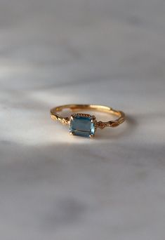 Topaz Dainty Ring: Minimalist 925 Sterling Silver, 18K Gold Plated Emerald Cut Ring 💍✨ Add a touch of elegance to your jewelry collection with our exquisite Topaz Dainty Ring. Featuring a mesmerizing emerald-cut topaz gemstone set in minimalist 925 sterling silver and plated with luxurious 18K gold, this ring is both sophisticated and versatile. Its adjustable band ensures a comfortable fit, making it the perfect gift for her for any occasion. 💙 Key Features: Emerald Cut Topaz: Highlights a st Dainty Yellow Gold Topaz Ring Gift, Elegant Everyday Topaz Ring, Gold Dainty Wedding Rings, Topaz Rings, Emerald Cut Ring, Emerald Ring Gold, Zierlicher Ring, Emerald Cut Rings, Topaz Engagement Ring