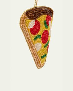 a beaded ornament shaped like a slice of pizza hanging from a chain