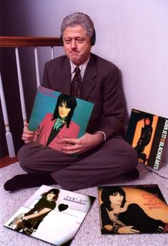 a man sitting on the floor with some books