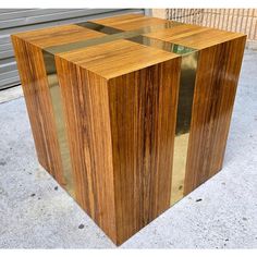 a large wooden box sitting on top of a sidewalk