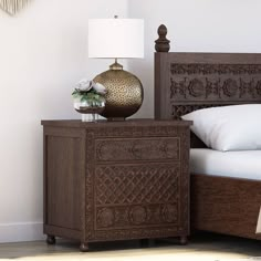 a bedroom with a bed, night stand and lamp on top of the nightstands