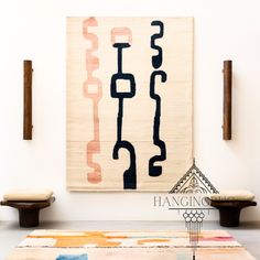 an abstract rug is hanging on the wall