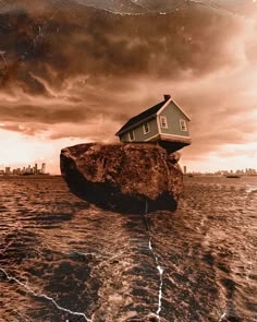 a house sitting on top of a rock in the middle of water with storm clouds overhead