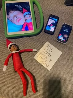 an elf is laying on the couch next to some cell phones and a tablet computer