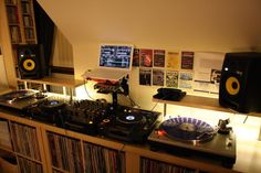 a record player is sitting on top of a shelf in front of a laptop computer