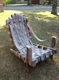 a chair made out of cardboard sitting in the grass