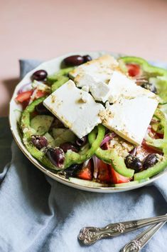 a salad with feta cheese and black olives