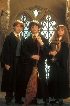 three young harry potter children standing in front of a window with broom and book title clean dishes