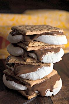 a stack of cookies covered in chocolate and marshmallows