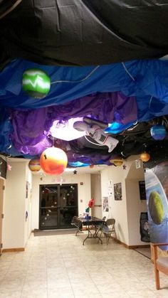 the inside of an office building with blue tarps on the ceiling and decorations hanging from the ceiling