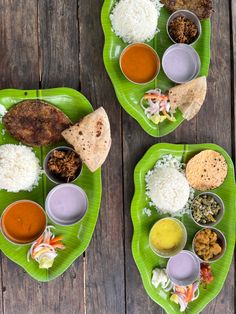 two plates filled with different types of food on top of a wooden table next to each other