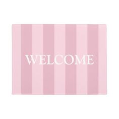 a welcome mat with pink and white stripes