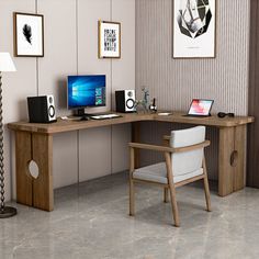 a computer desk with a chair next to it and pictures on the wall behind it