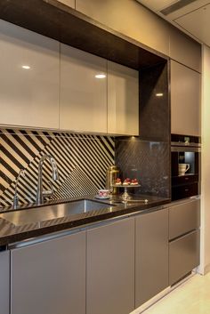 a kitchen with stainless steel appliances and black counter tops