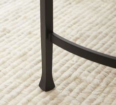 a close up view of a metal bed frame and foot board on a white carpeted floor