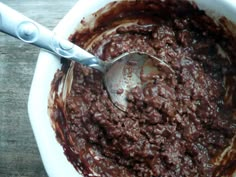 a spoon is in a bowl full of chocolate cake batter, and it's ready to be eaten