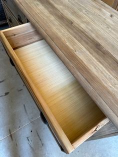 an open drawer on top of a wooden table