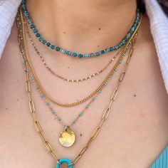 Fall in love with our Mykonos Coin Necklace - the perfect addition to your vacation wardrobe. This stunning piece features a detailed turquoise enamel chain and a hammered disc charm for a chic and stylish look. Make a statement with this beautiful accessory. 3/4 inch coin disc charm in 14kt gold fill or sterling silver 14kt gold fill or sterling silver turquoise color enamel accented chain available in 16,18, or 20-inch chain length