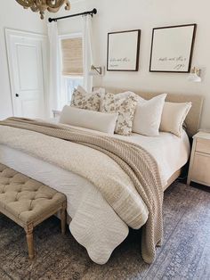 a bedroom with a large bed and white walls