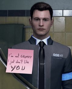 a man in a suit and tie holding a note with the words i'm not grumpy, just don't like you