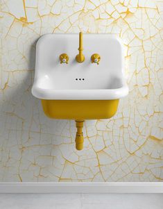 a white sink sitting next to a yellow wall