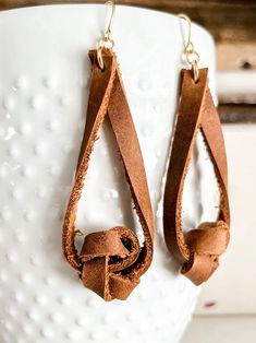 Lovely, hand-cut trendy genuine leather earrings.  Hung on hypoallergenic earrings.  My husband started doing leatherwork a few years ago and I decided to do something pretty with his leftover leather! Handmade Leather Jewelry, Double Knot, Knot Earrings, Hypoallergenic Earrings, Leather Fringe, Do Something, Leather Earrings, Leather Jewelry, Handmade Leather