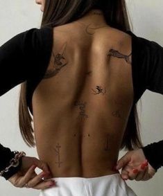 the back of a woman with tattoos on her upper and lower part of her body