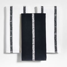 two black and white towels on top of each other next to one another with the words,