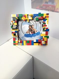 a photo frame made out of legos with a woman in the water on it