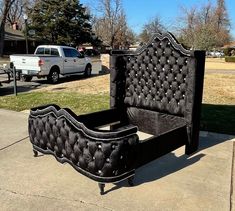 a black bed sitting on top of a sidewalk