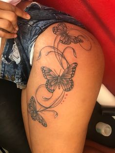 a woman's thigh with butterflies on it