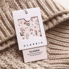 a close up of a sweater with a tag attached to it's front and back