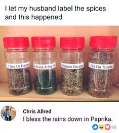 four jars filled with spices sitting on top of a shelf