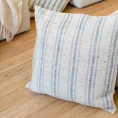 three striped pillows on the floor next to each other