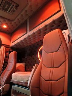 the interior of a vehicle with leather seats and red lighting in the back area is shown