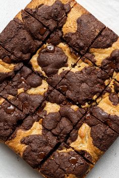 chocolate chip cookie bars cut into squares on a white surface