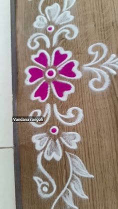 some white and pink flowers painted on wood