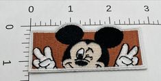 a mickey mouse patch is shown on a ruler