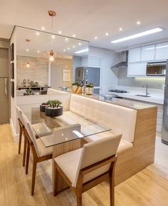 a modern kitchen and dining room with wood flooring