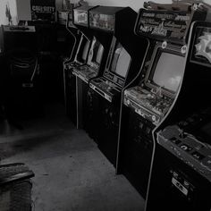 several old fashioned video game machines lined up in a room